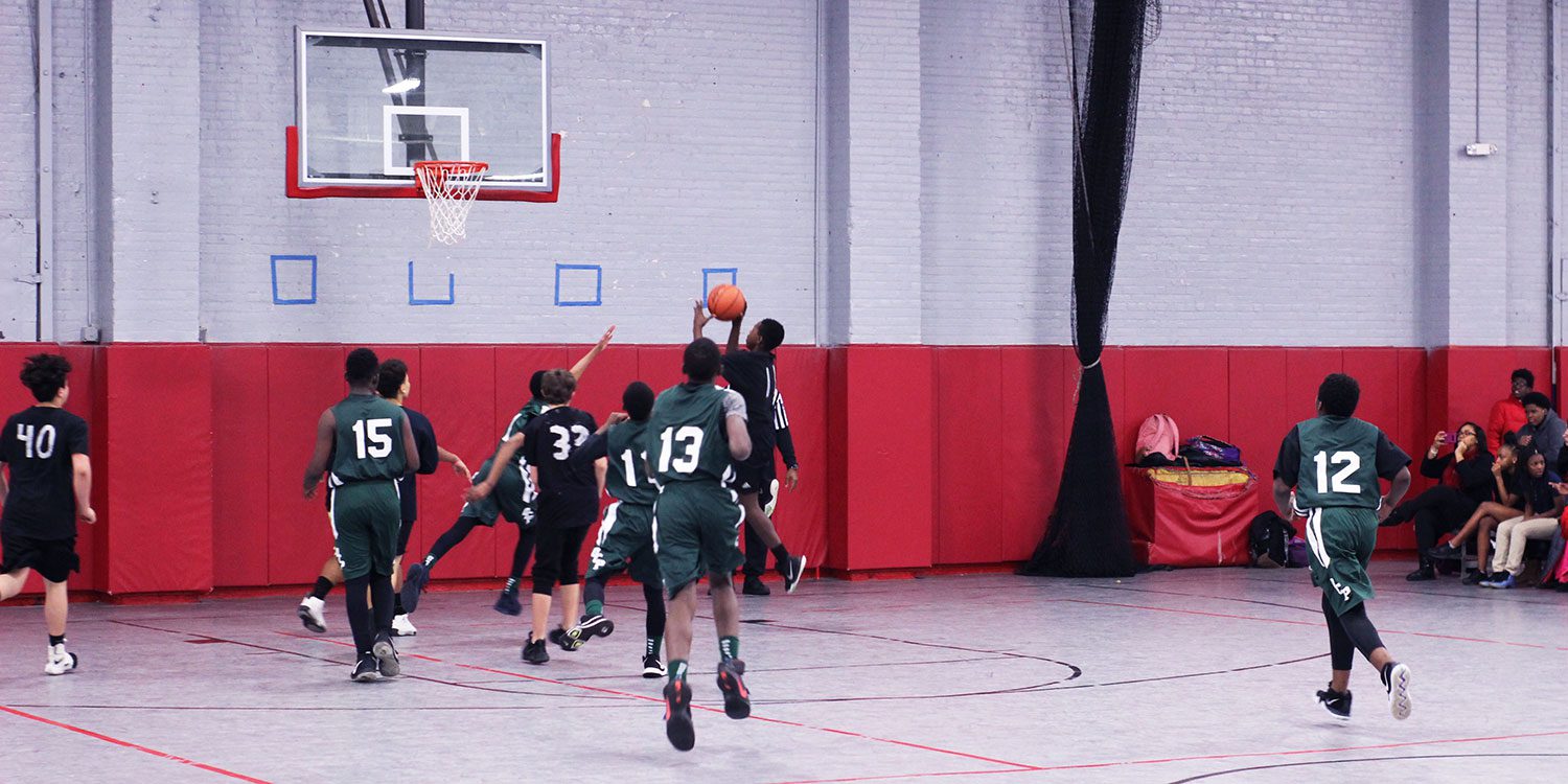 OCP basketball team playing in a game against another school.