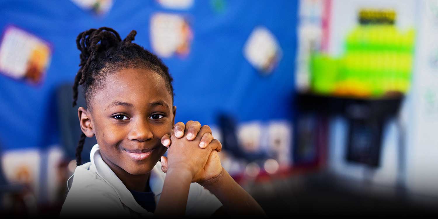 Smiling student in a classroom.
